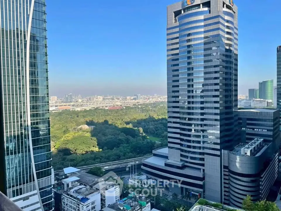 Stunning cityscape view from a high-rise building showcasing modern architecture and lush greenery.