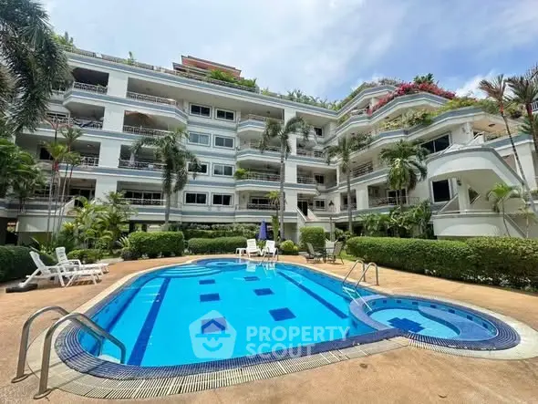 Luxurious apartment complex with stunning pool and lush greenery