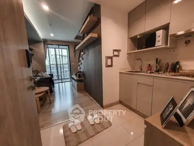 Modern open-layout apartment with cozy living room and stylish kitchen, featuring wooden accents and city view balcony.