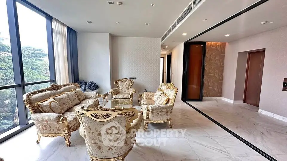Luxurious living room with elegant furniture and large windows offering scenic views.
