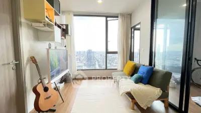 Modern living room with city view, stylish decor, and natural light.