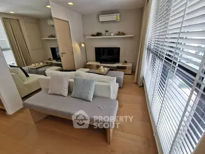 Modern living room with stylish decor and large windows for natural light