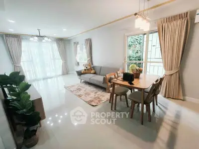Spacious living room with dining area and large windows in modern apartment