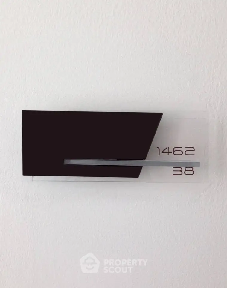 Modern apartment number sign with sleek design and minimalist style.