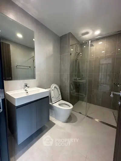 Modern bathroom with sleek design, glass shower, and contemporary fixtures.