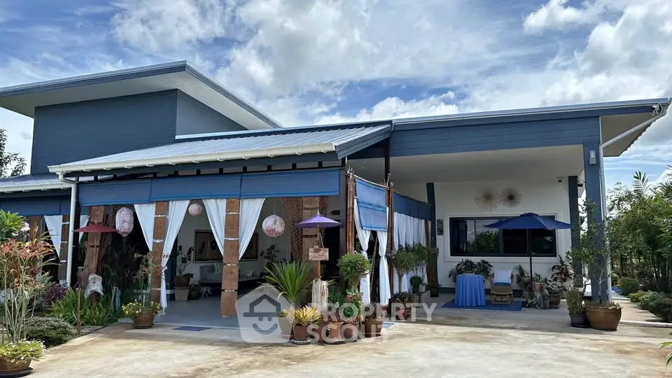 Charming modern house with spacious patio and lush garden, perfect for serene living.