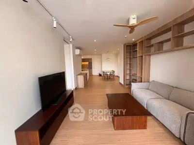 Spacious modern living room with wooden flooring and stylish furniture