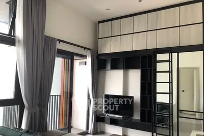 Modern living room with high ceilings and stylish built-in shelving