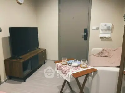 Cozy living room with modern TV stand and comfortable seating, perfect for relaxation.