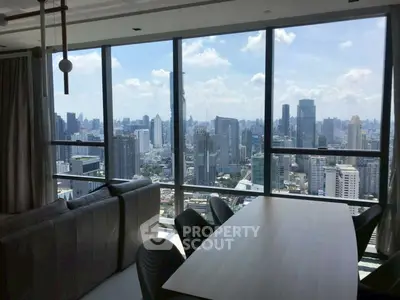 Stunning cityscape view from a modern high-rise apartment with floor-to-ceiling windows.