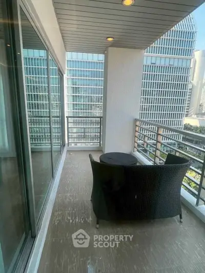 Spacious balcony with city view in modern high-rise apartment