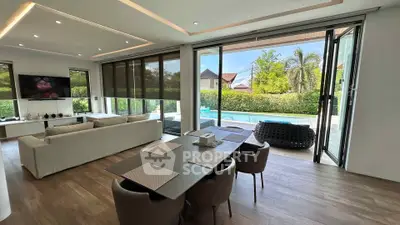 Luxurious open-plan living room with pool view and modern decor