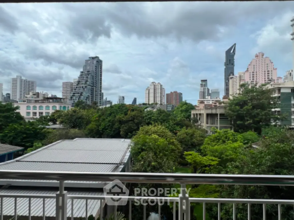 Stunning cityscape view from balcony with lush greenery and modern skyline