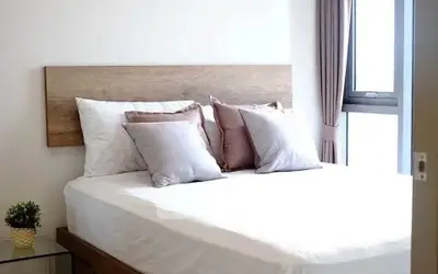 Cozy bedroom with modern decor and large window for natural light