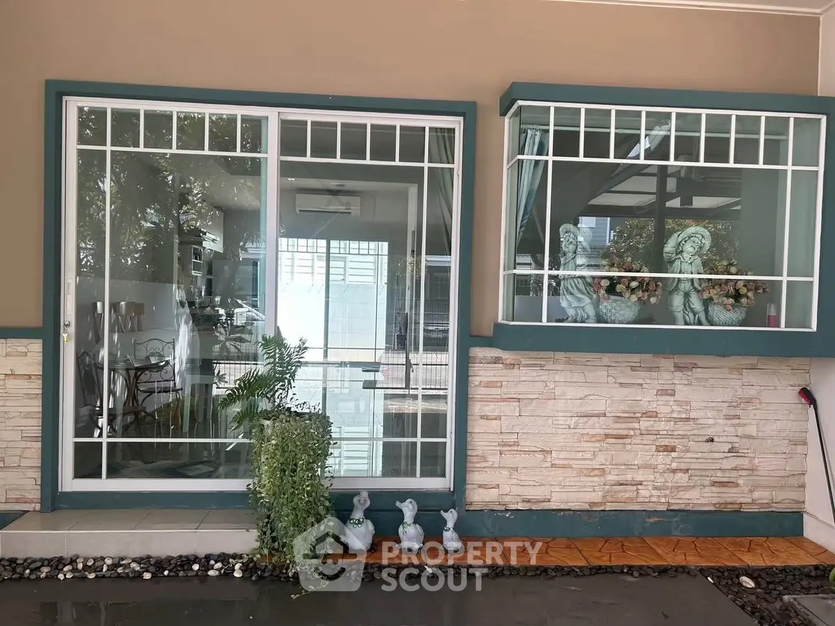 Charming home entrance with decorative statues and lush greenery