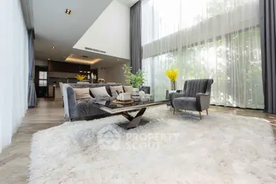 Luxurious modern living room with high ceilings and large windows