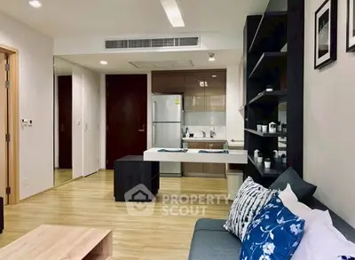 Modern open-plan living room with stylish kitchen and cozy seating area.