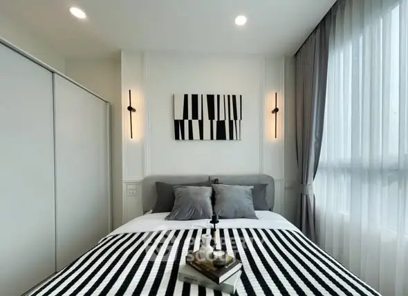Modern bedroom with stylish decor and ample natural light