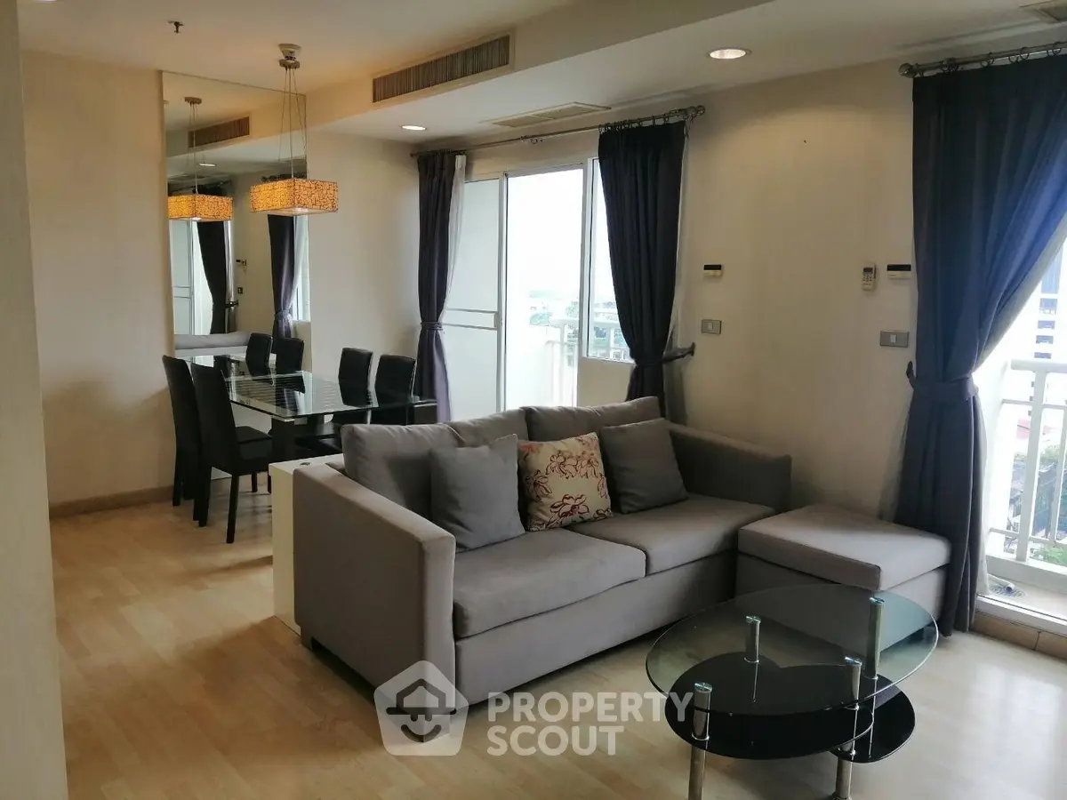 Spacious living room with modern decor and balcony view