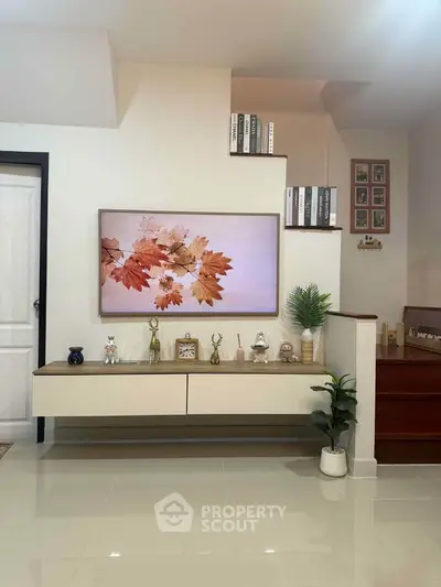 Stylish living room with modern decor and elegant wall-mounted TV display.