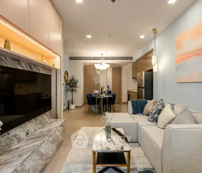 Luxurious modern living room with elegant decor and open layout, featuring a stylish dining area and contemporary kitchen.