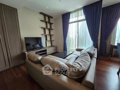 Luxurious living room with elegant sofa, TV, and floor-to-ceiling windows with stunning curtains.