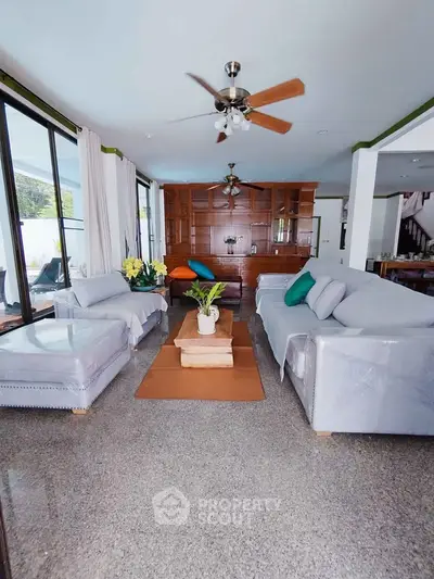 Spacious living room with modern decor and large windows for natural light.
