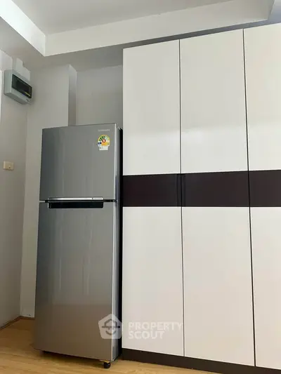 Modern kitchen with sleek refrigerator and stylish cabinetry