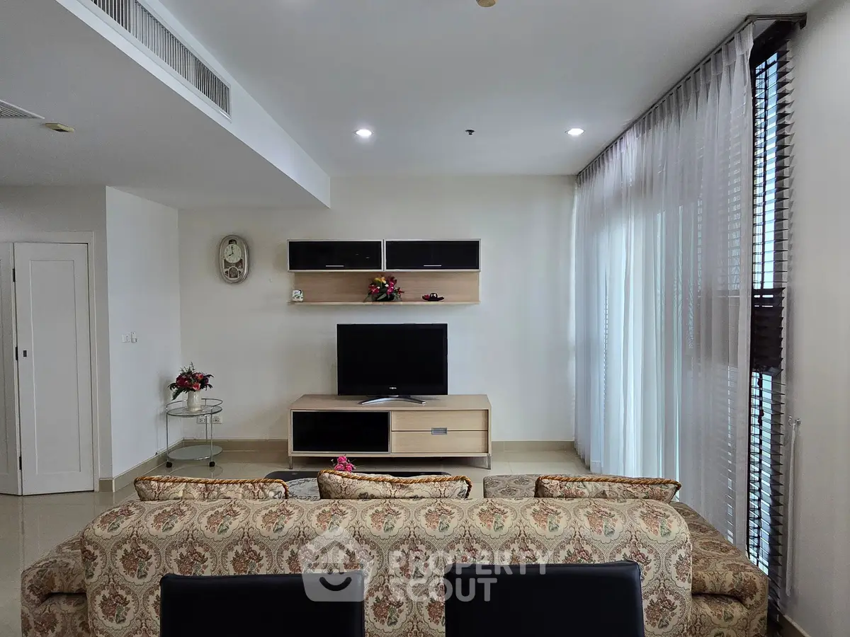 Elegant living room with stylish decor and modern entertainment center, perfect for relaxation and entertainment.