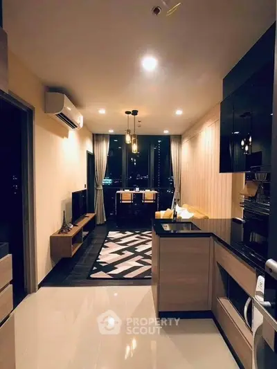 Modern open-layout living room with kitchen, stylish decor, and city view.