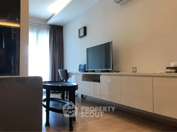 Modern living room with sleek TV setup and stylish furniture