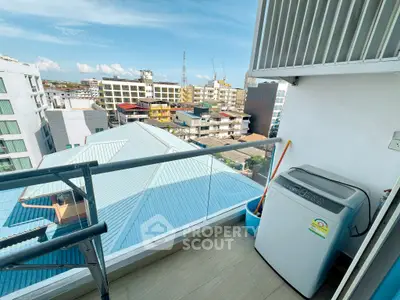 Modern balcony with city view and washing machine, ideal for urban living.