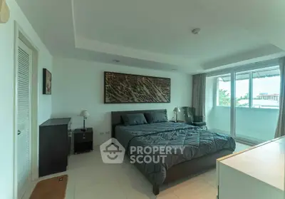 Spacious bedroom with modern decor and large balcony access, offering ample natural light and serene views.