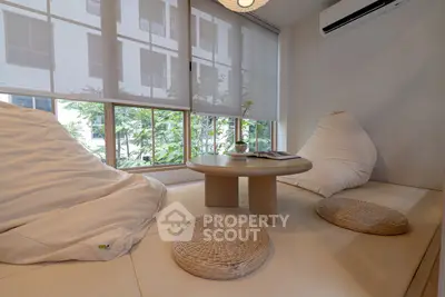 Cozy modern living room with large windows and minimalist decor