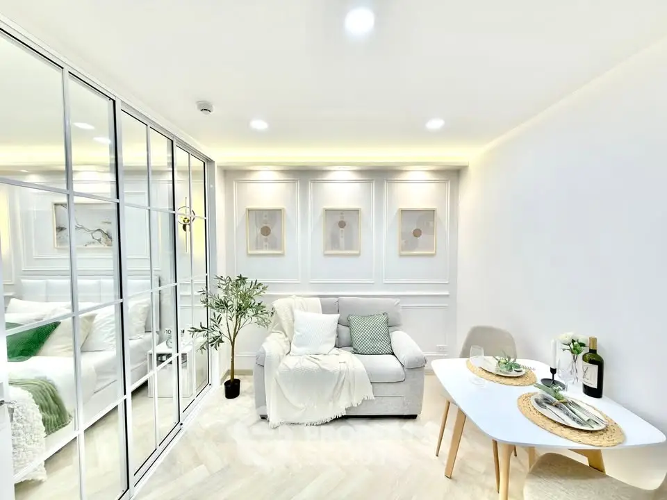 Bright and modern living room with elegant decor and cozy seating area, perfect for relaxation.