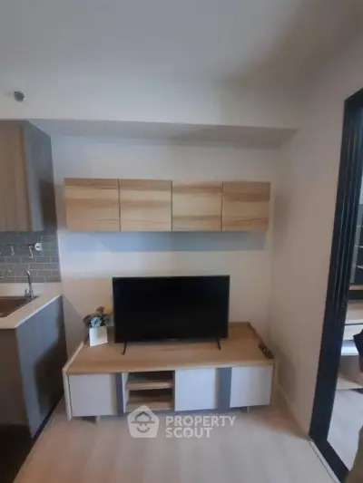 Modern living room with sleek TV setup and stylish wooden cabinets