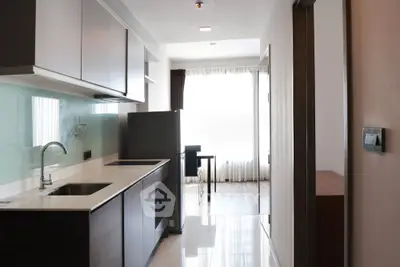Modern kitchen with sleek cabinetry and open layout in a bright apartment