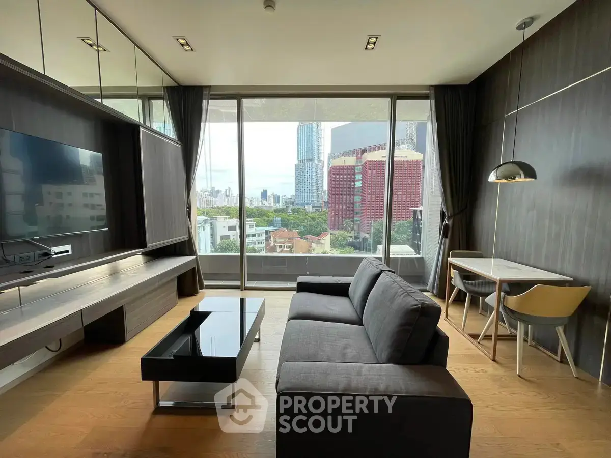 Modern living room with city view, sleek furniture, and floor-to-ceiling windows in urban apartment.