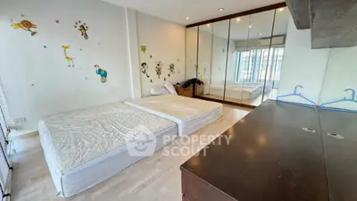 Spacious bedroom with mirrored wardrobe and playful wall decals