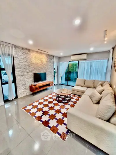 Spacious modern living room with stylish decor and large windows for natural light.