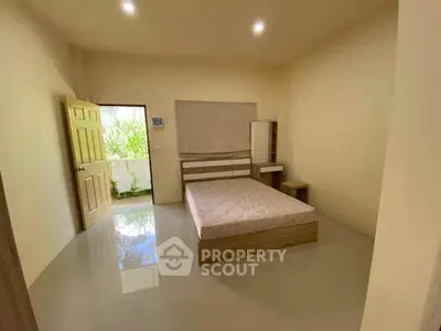 Spacious bedroom with natural light and minimalist decor