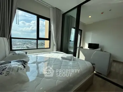 Modern bedroom with large window offering stunning city view, featuring a cozy bed and stylish decor.