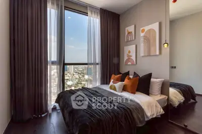 Luxurious bedroom with floor-to-ceiling window offering stunning city views, modern decor, and elegant furnishings.