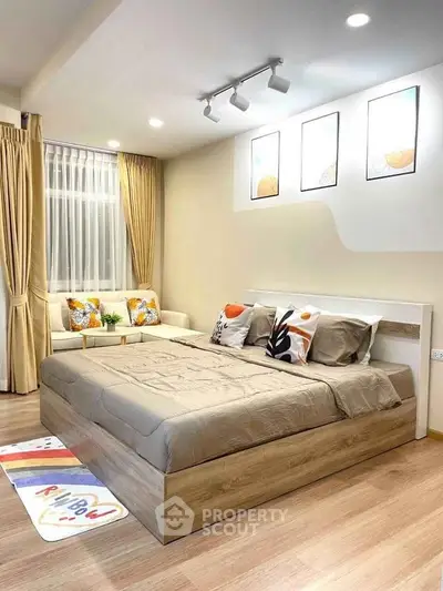 Modern bedroom with stylish decor and cozy seating area, perfect for relaxation.