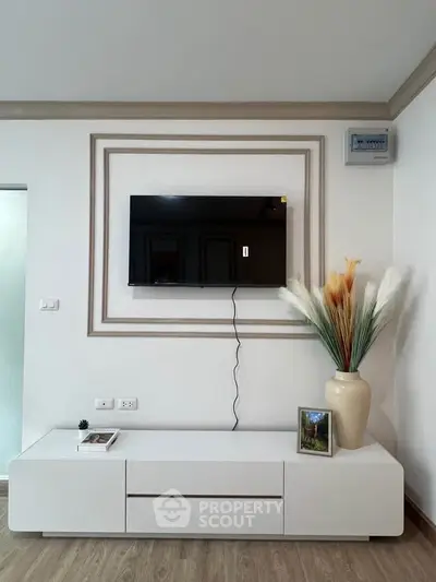 Modern living room with wall-mounted TV and stylish decor