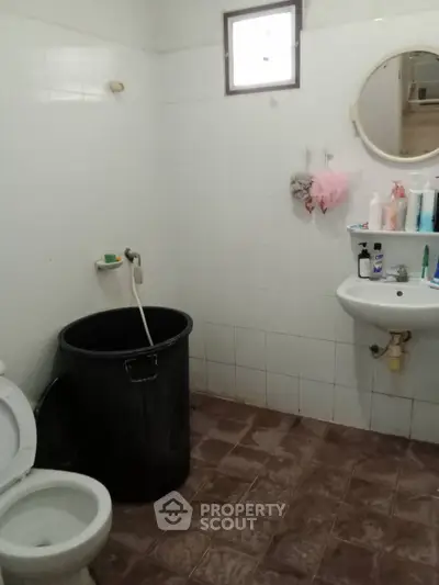 Simple bathroom with basic fixtures and tiled floor