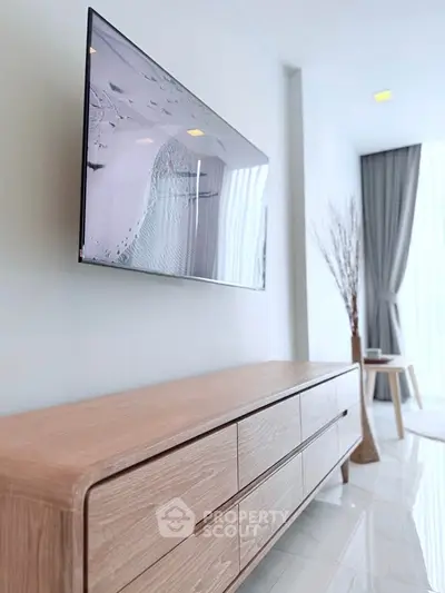Modern living room with sleek TV and stylish wooden console