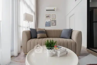 Modern living room with stylish sofa and decor in bright natural light.