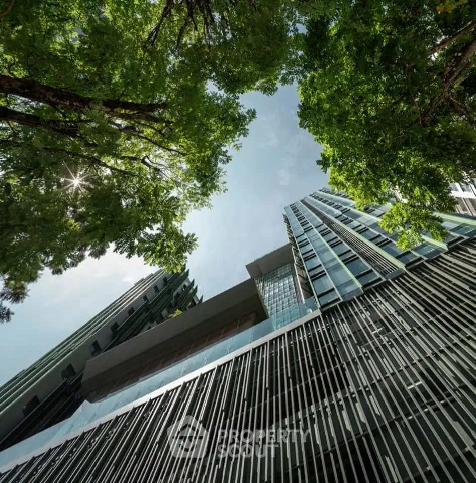 Modern architectural building with sleek design and lush green trees, showcasing urban elegance.