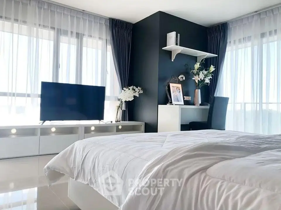 Modern bedroom with large windows and sleek decor